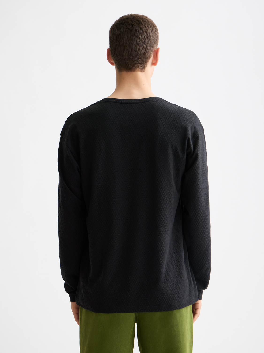 Scotch & Soda jacquard long-sleeved T-shirt with intricate pattern, black color, and comfortable fit, displayed on a plain background.