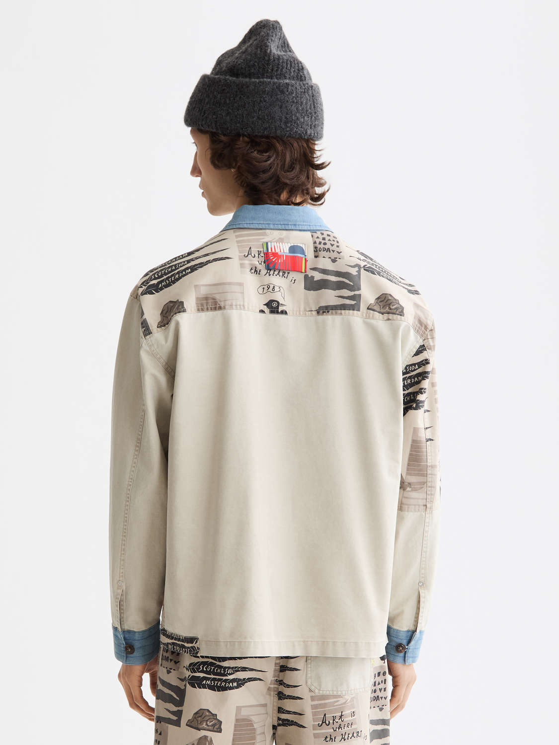 Printed worker jacket by Scotch & Soda, showing the back design with bold patterns and durable fabric for workwear style.