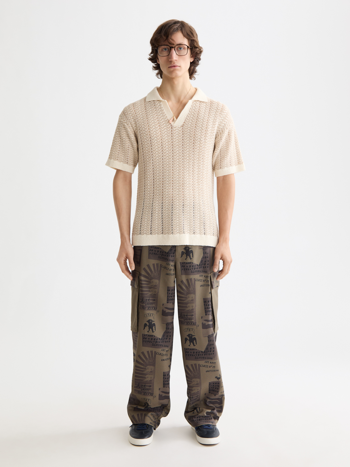 Printed cargo pants from Scotch & Soda featuring multiple pockets and a relaxed fit, shown in a front view.