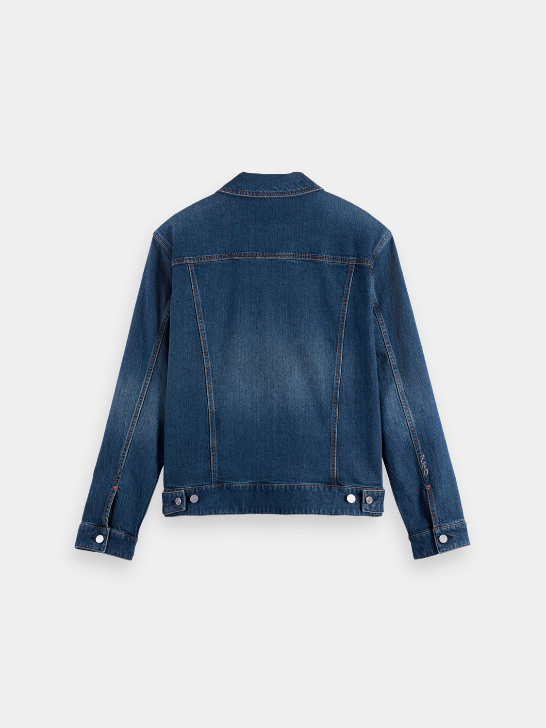 Dark blue Scotch & Soda denim trucker jacket with classic collar, button front, and chest pockets, displayed on a hanger.