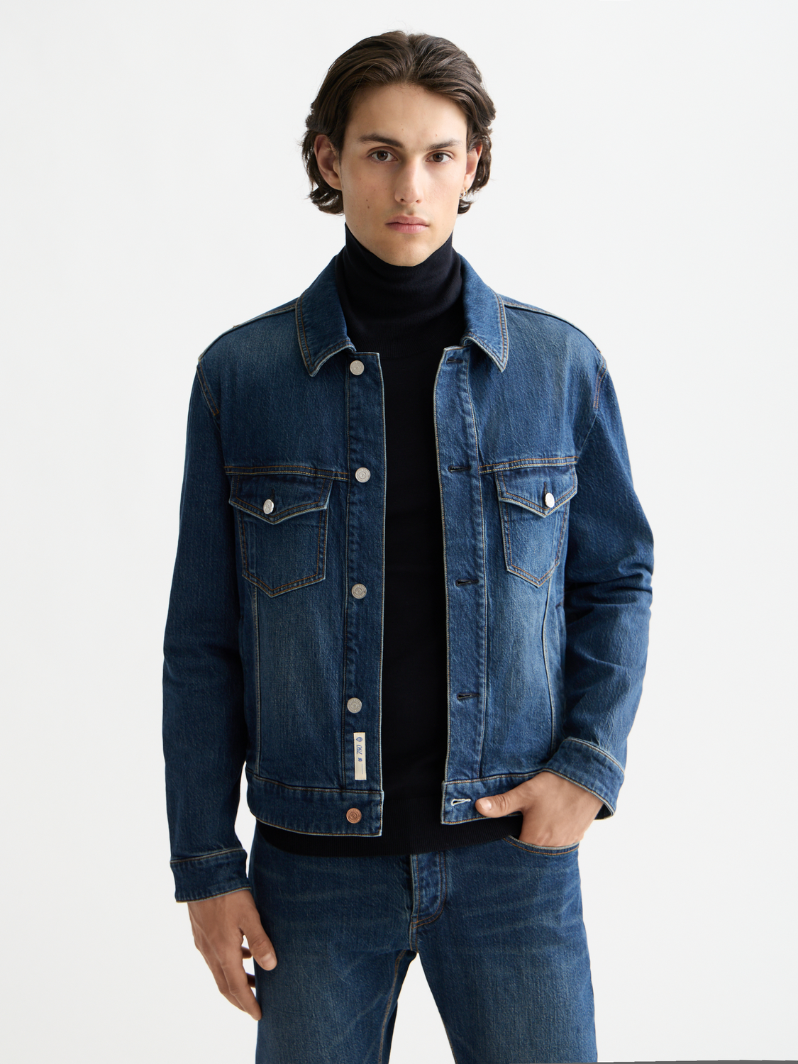 SCOTCH & SODA denim trucker jacket with classic design, button closure, and chest pockets, displayed on a hanger.
