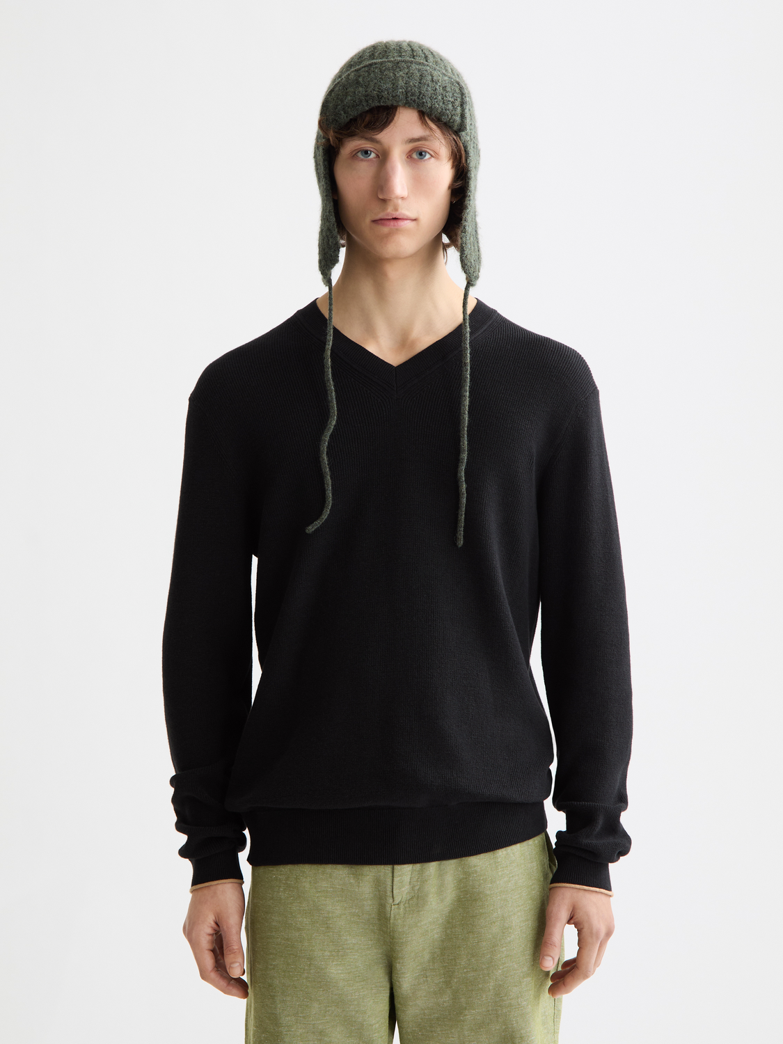 Scotch & Soda V-neck knit pullover in soft fabric, featuring a classic design and ribbed cuffs on a neutral background.