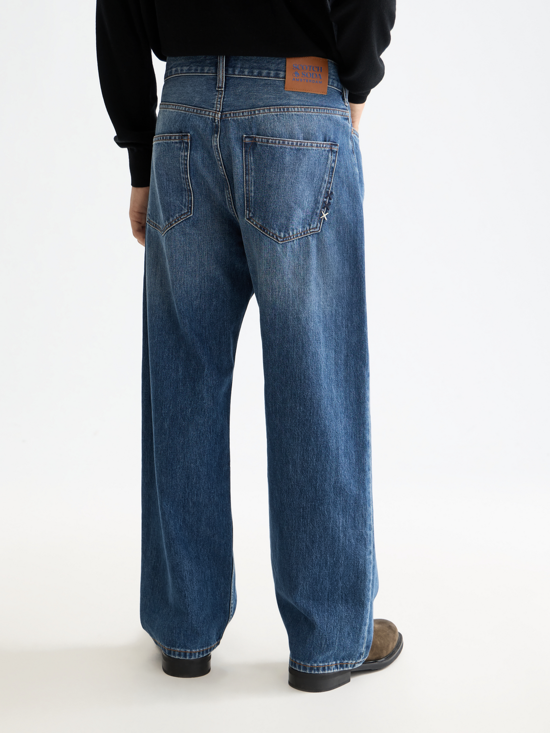 Back view of Scotch & Soda pitch loose-fit denim jeans with faded wash and relaxed fit, showing classic five-pocket design.