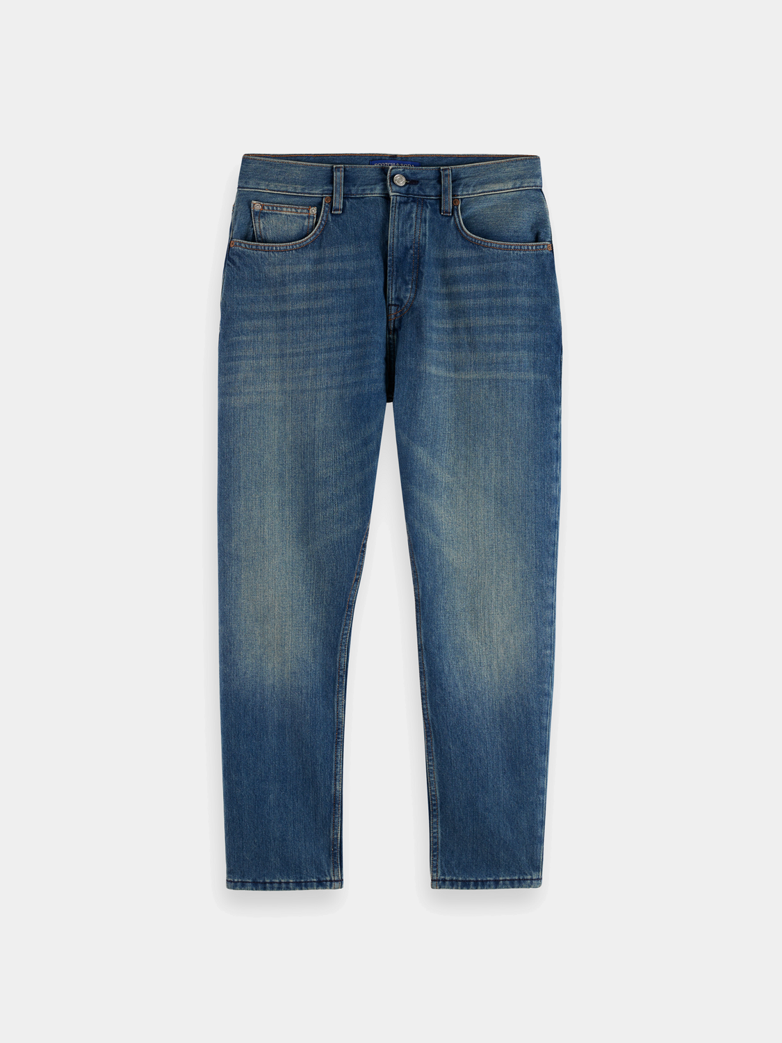 SCOTCH & SODA Dean tapered denim jeans featuring a classic fit and dark wash, displayed on a neutral background.