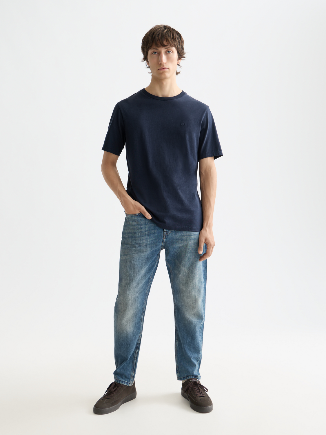 Scotch & Soda Dean tapered denim jeans showing a slim fit design with classic five-pocket style and medium blue wash.