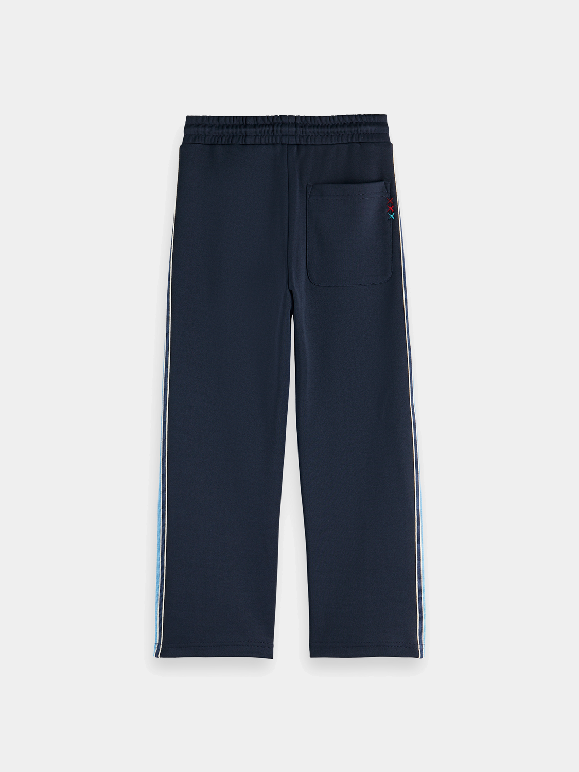 Kids' interlock track pants by Scotch & Soda, navy blue sweatpants with elastic waistband and relaxed fit, front and back view.