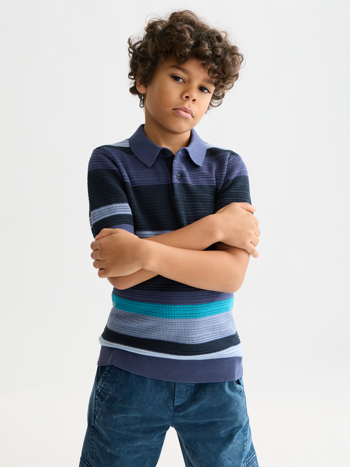 Kids striped knitted polo shirt by Scotch & Soda, featuring colorful horizontal stripes and a classic polo collar.