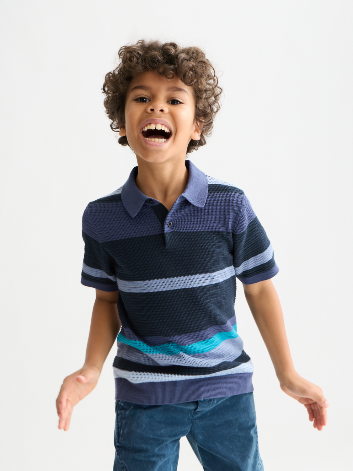 Kids' striped knitted polo shirt by Scotch & Soda, featuring a classic collar and vibrant color stripes.
