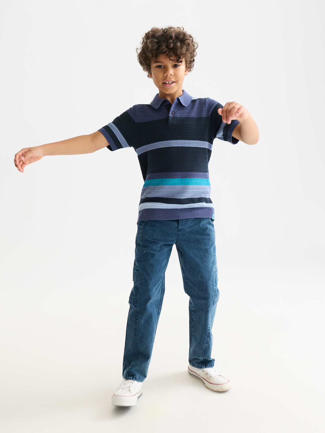 Kids striped knitted polo shirt by Scotch & Soda, featuring colorful horizontal stripes and a classic collar.
