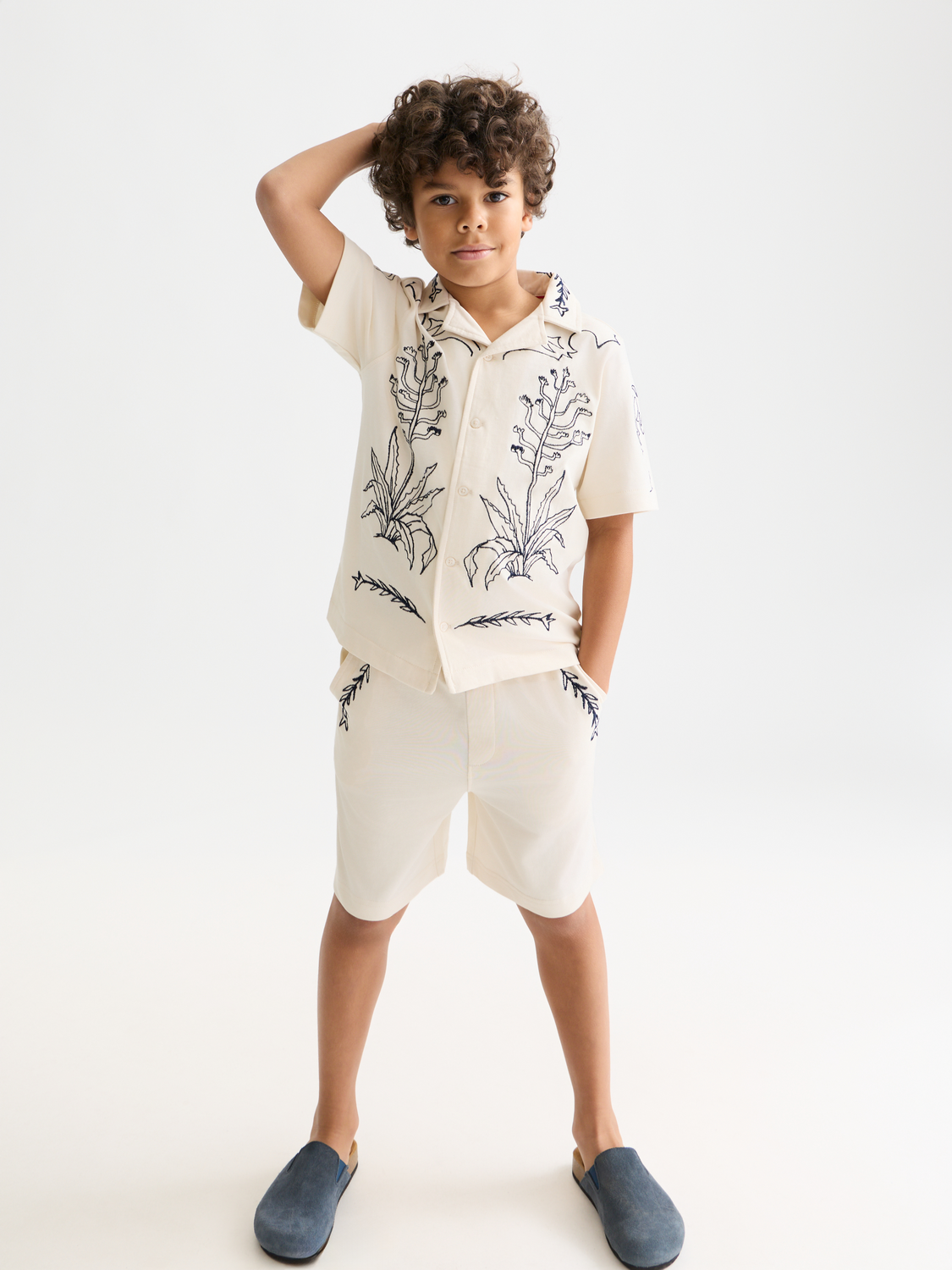 Kids printed short-sleeved shirt by Scotch & Soda featuring colorful patterns on lightweight fabric.