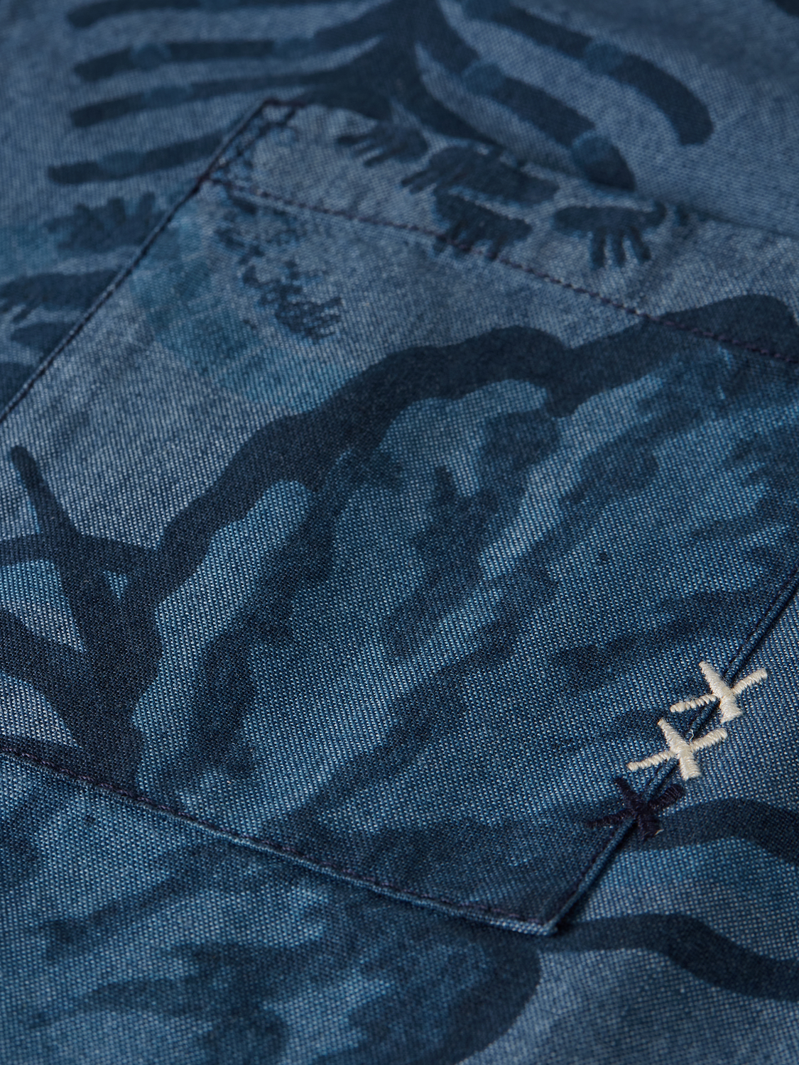 Kids' printed short-sleeved shirt by Scotch & Soda, featuring colorful patterns and lightweight cotton fabric.
