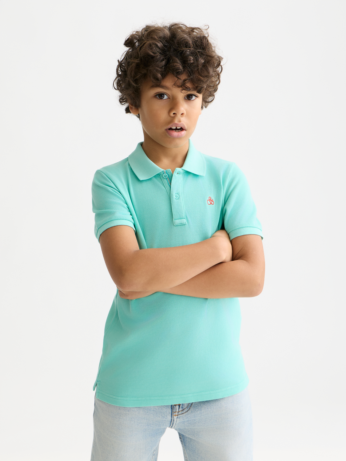 Kids' garment-dyed pique polo shirt by Scotch & Soda, showing front view with collar and short sleeves.