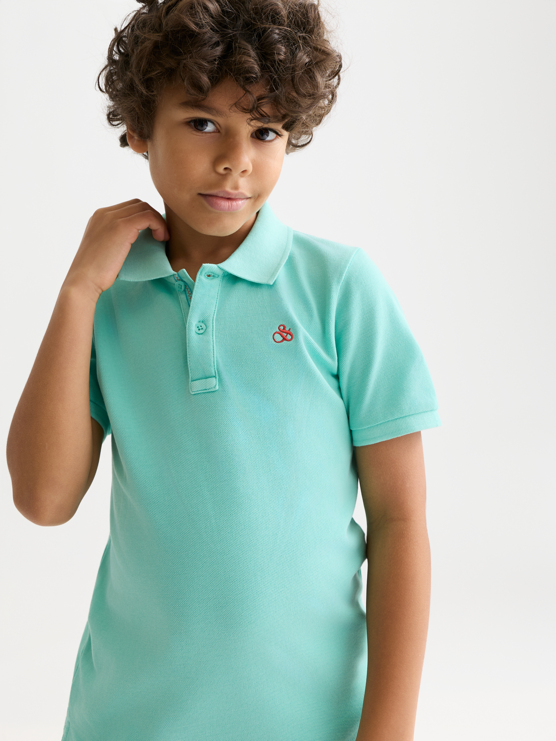 Kids' garment-dyed pique polo shirt by Scotch & Soda, featuring a classic collar and short sleeves.