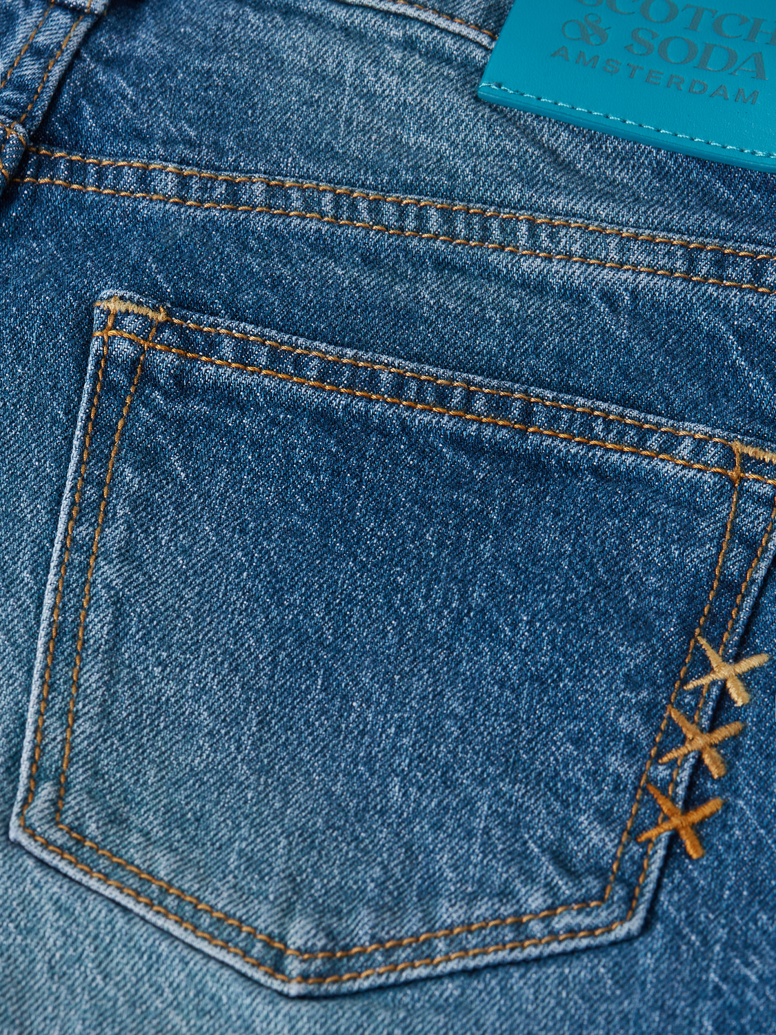 Kids' loose-fit denim jeans by Scotch & Soda, showing the casual, relaxed fit and classic blue color.
