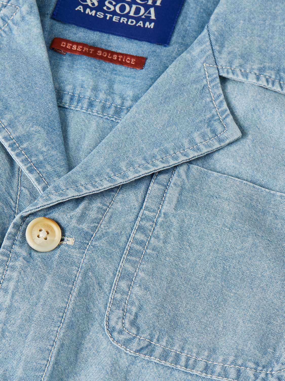 Kids chambray playsuit by Scotch & Soda, featuring a comfortable jumpsuit with short sleeves and button details, perfect for casual wear.