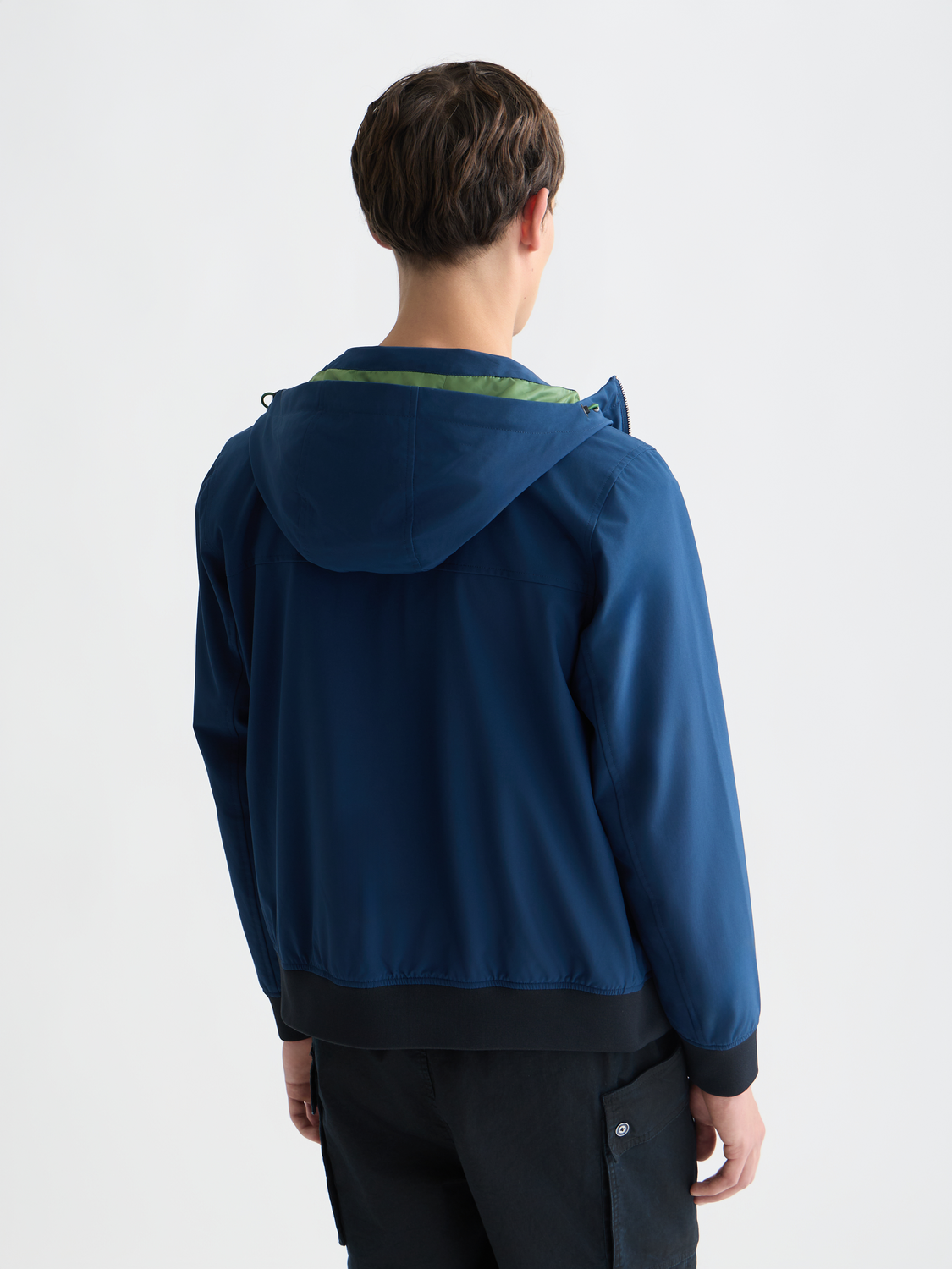 Blue Scotch & Soda softshell hooded jacket shown from the back, featuring a hood and sleek design, ideal for outdoor wear.