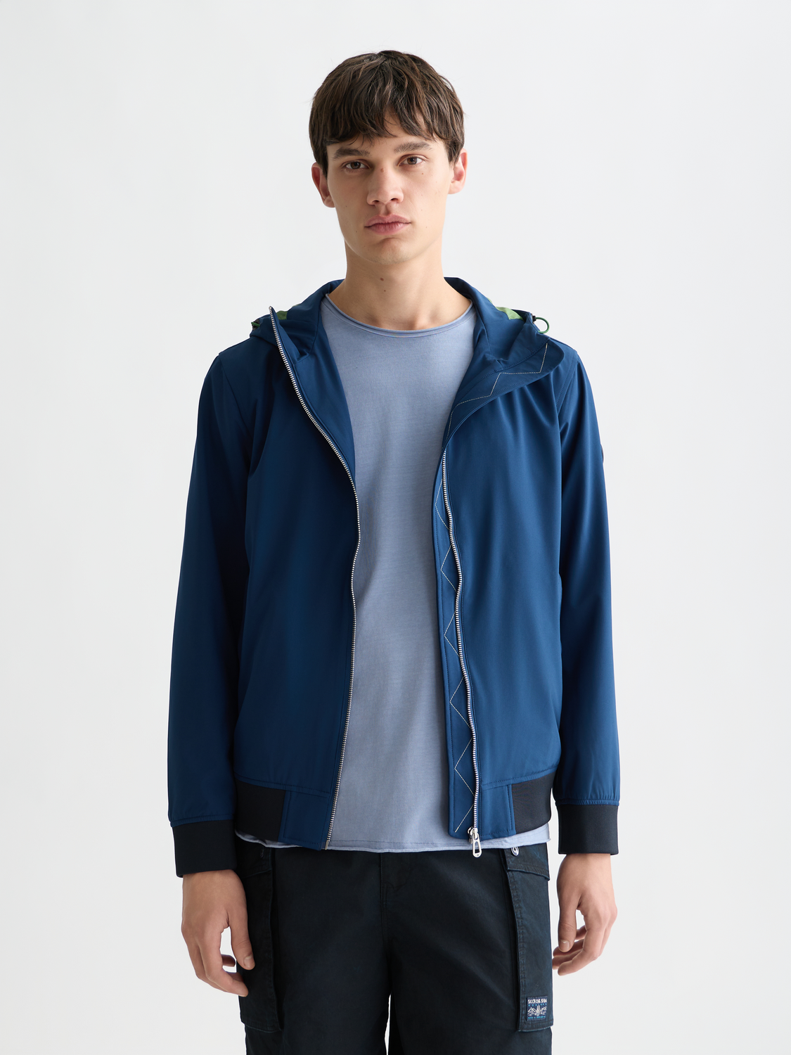 SCOTCH & SODA softshell hooded jacket with front zipper, shown in a close-up view highlighting the fabric and hood design.