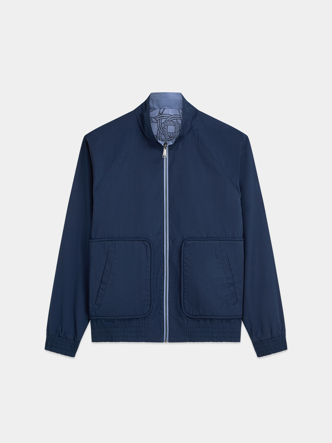 Reversible printed jacket from Scotch & Soda showing colorful pattern on one side and solid color on the other.
