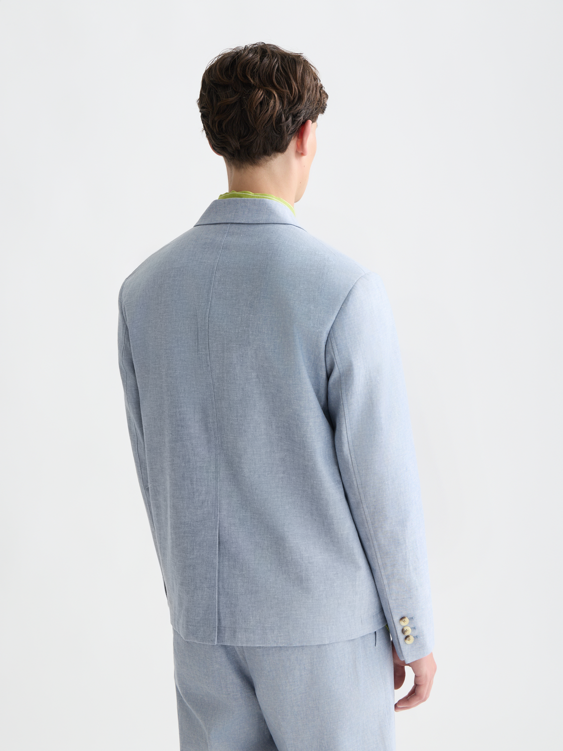 Unconstructed blazer from Scotch & Soda in navy with a tailored fit, shown from the back view highlighting fabric and stitching details.
