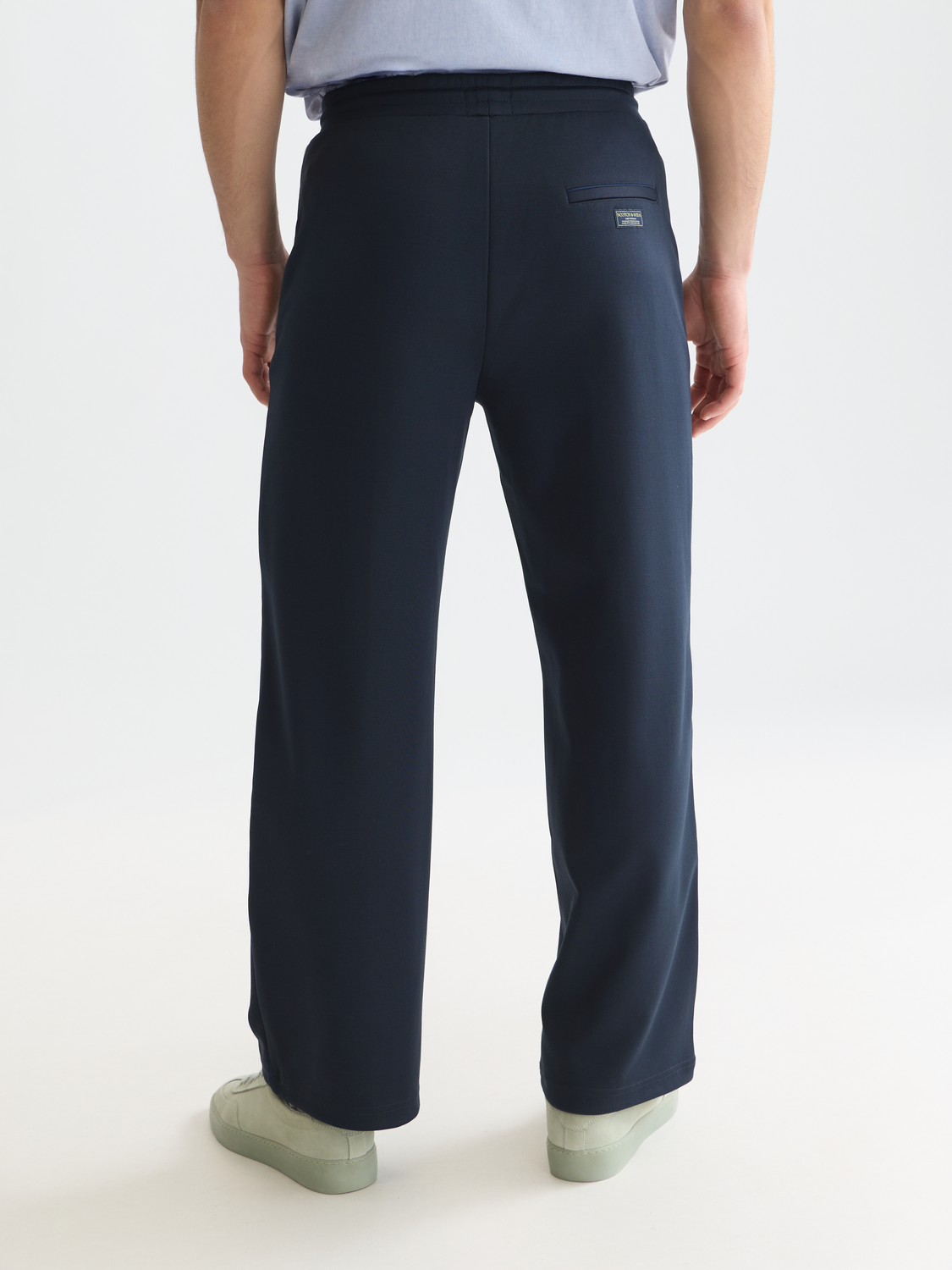 Back view of navy Scotch & SODA interlock sweatpants with elastic waistband and relaxed fit.