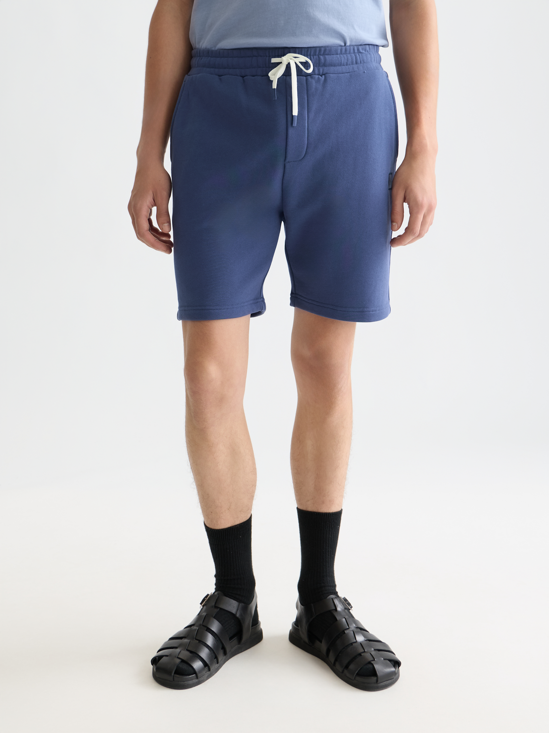 Scotch & Soda logo badge sweatshorts in black with front logo patch, casual athletic shorts for men.