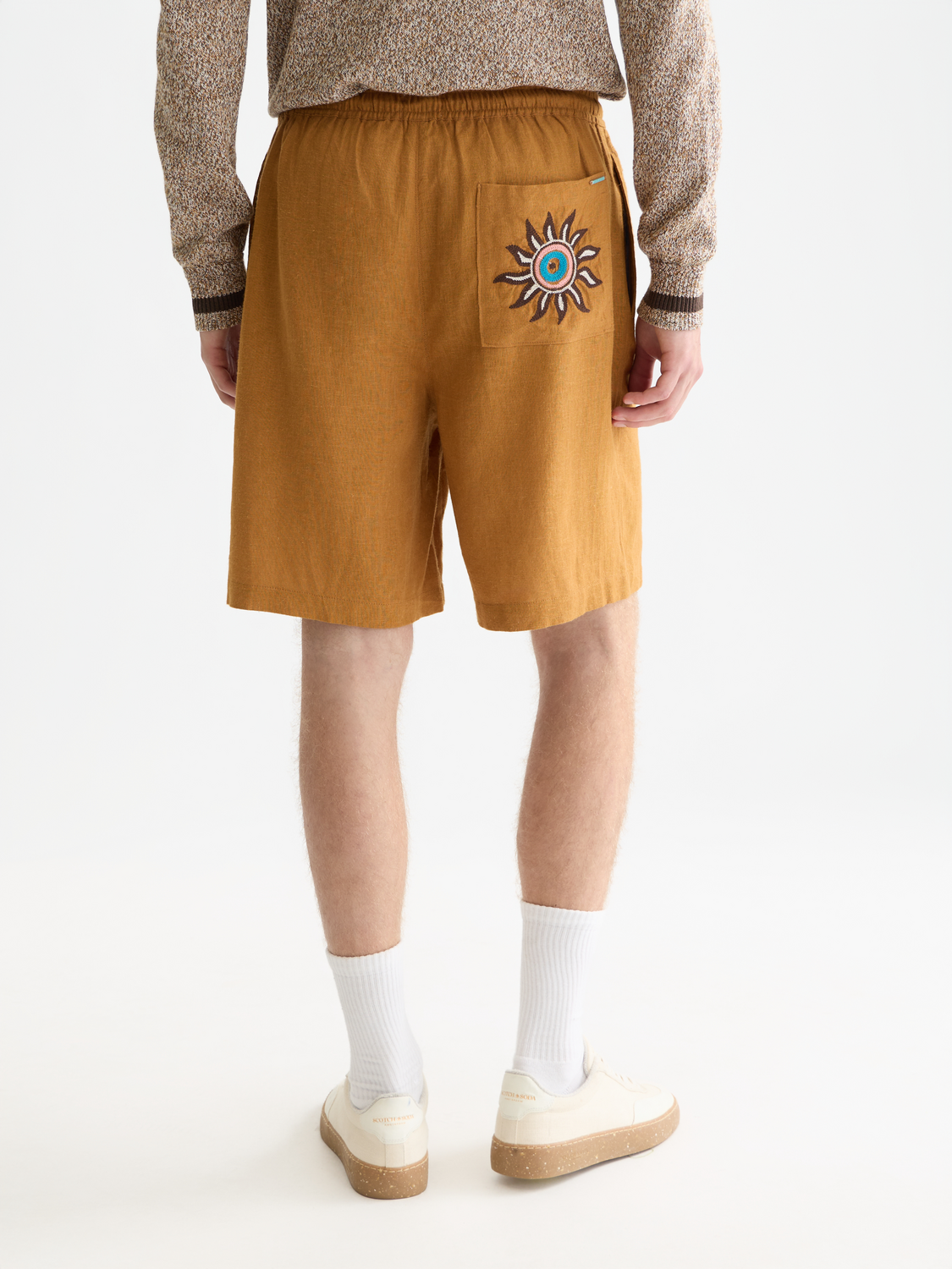 Embroidery detail on Scotch & Soda shorts with a back view, showcasing intricate stitching and stylish design.