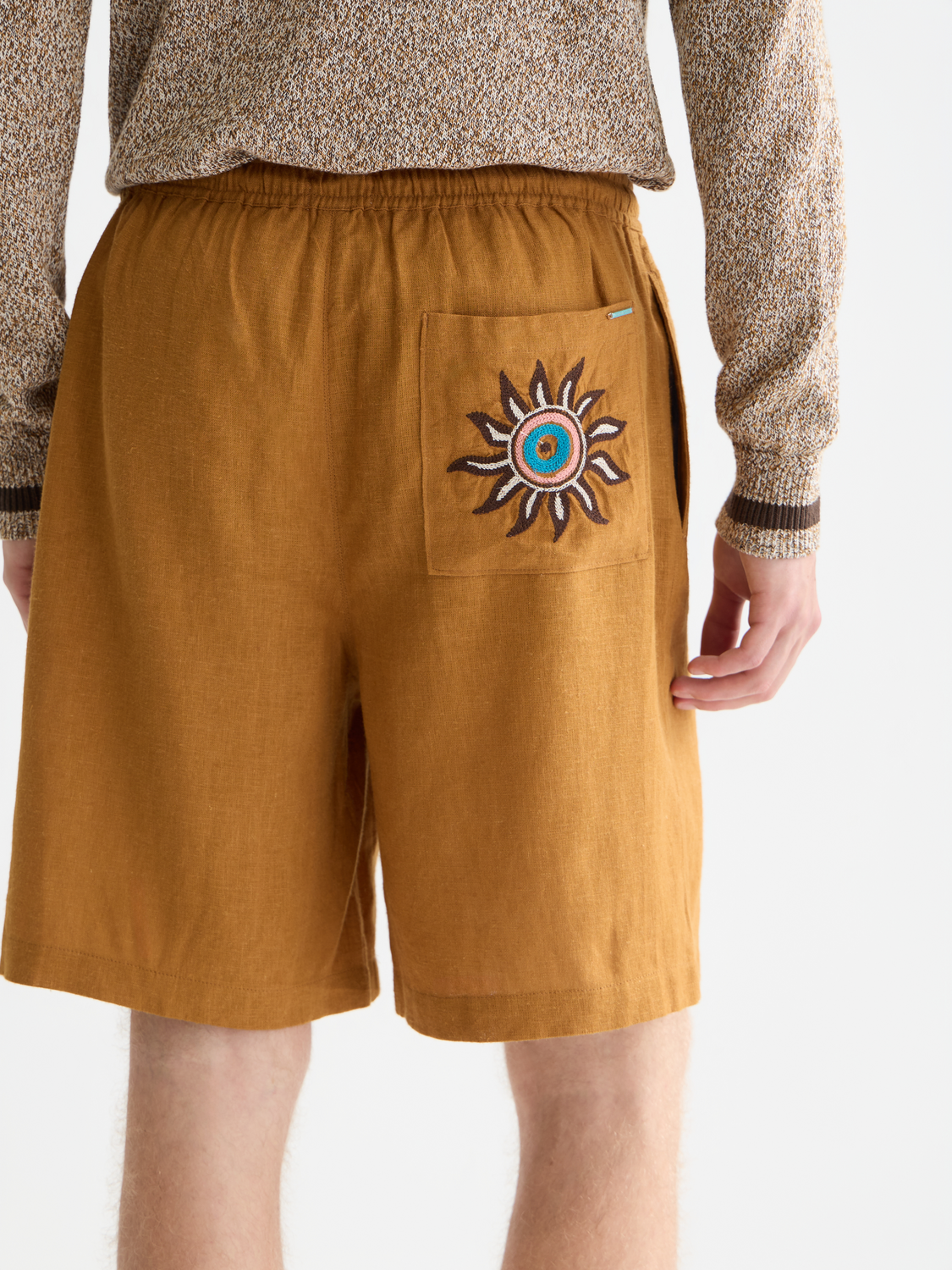 Embroidered shorts by Scotch & Soda featuring colorful floral embroidery and casual fit, displayed on a neutral background.