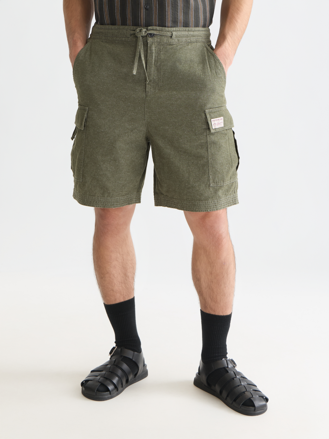 Scotch & Soda cargo linen shorts featuring a relaxed fit, multiple pockets, and a neutral beige color for casual summer wear.