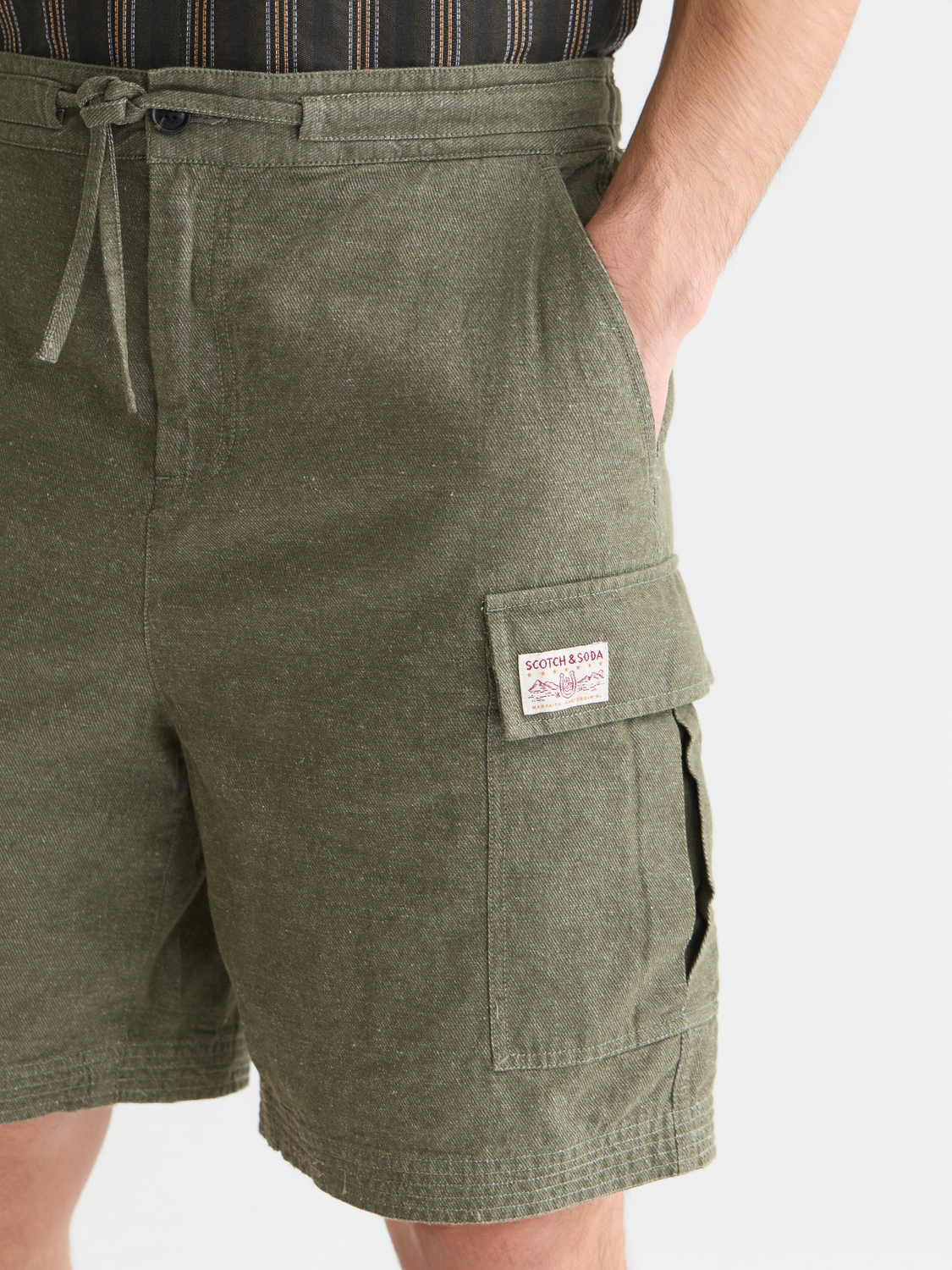 SCOTCH & SODA cargo linen shorts laid flat, showing front pockets and relaxed fit for casual summer wear.