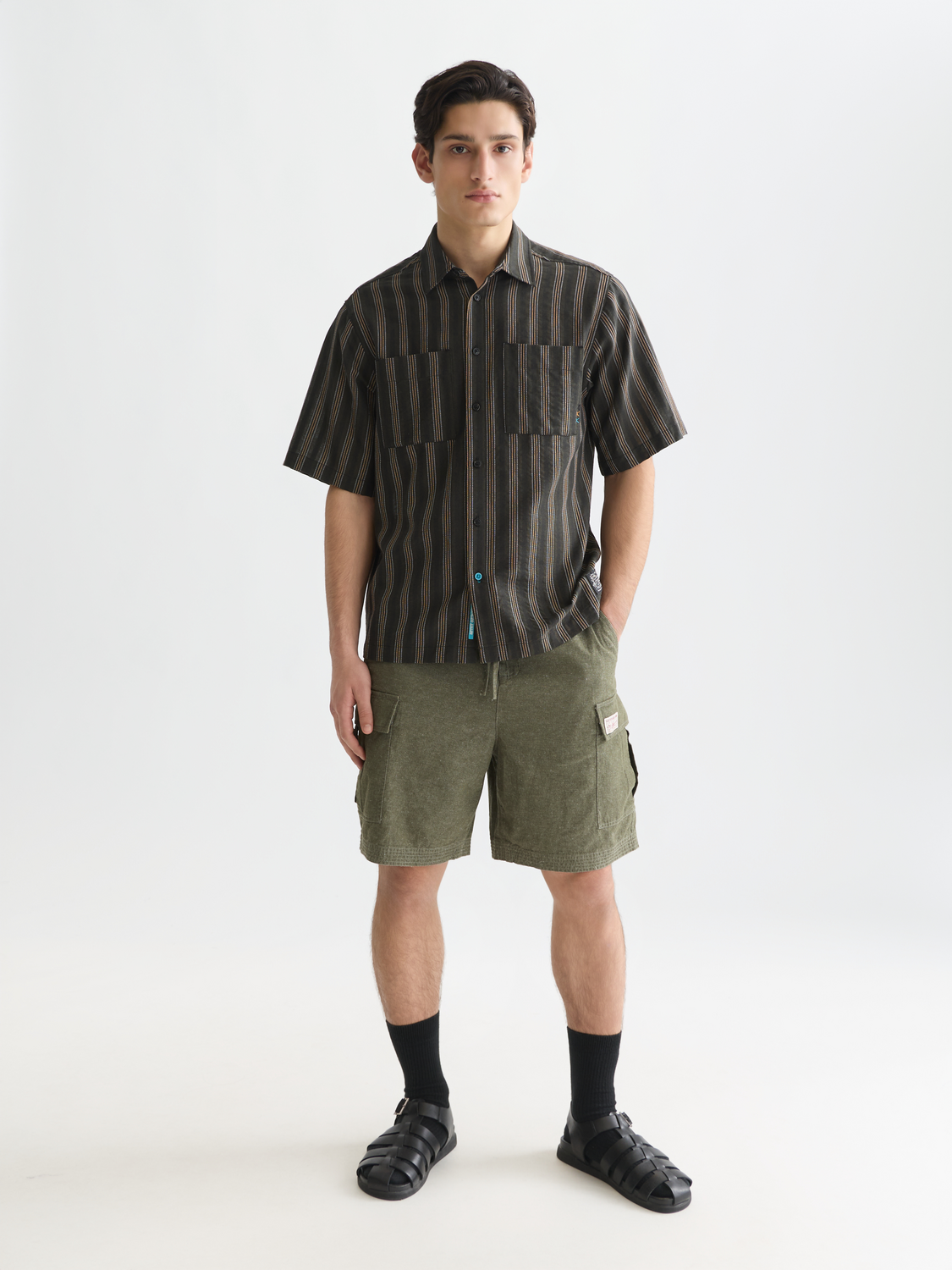 Light beige cargo linen shorts by Scotch & Soda, featuring multiple pockets and a relaxed fit, shown on a model.