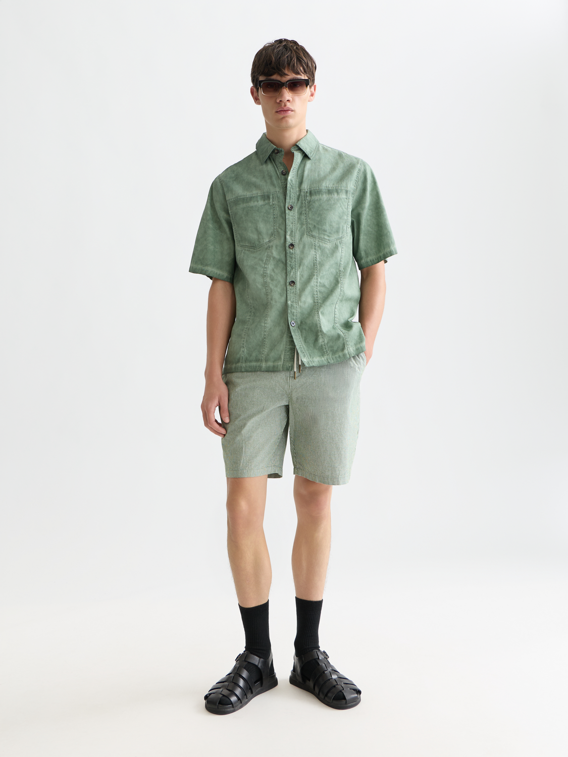 Light beige Fave cotton-linen shorts by Scotch & Soda, with a relaxed fit and side pockets, shown on a model.