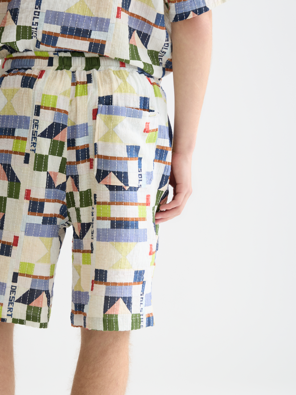 Printed stitched shorts by Scotch & Soda featuring colorful fabric, front pockets, and a relaxed fit.
