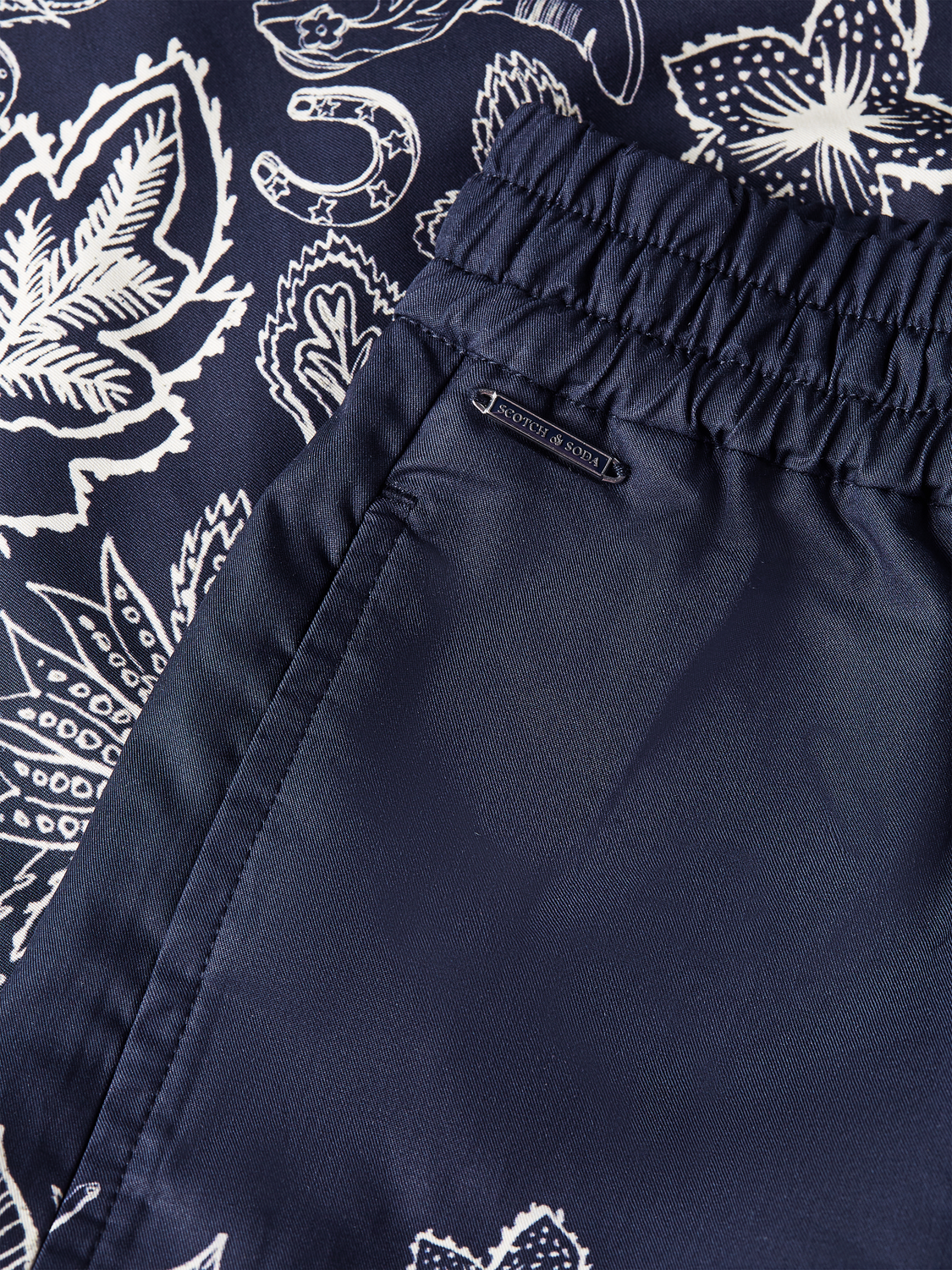 Printed shorts by Scotch & Soda featuring a colorful pattern, casual fit, and lightweight fabric perfect for summer wear.
