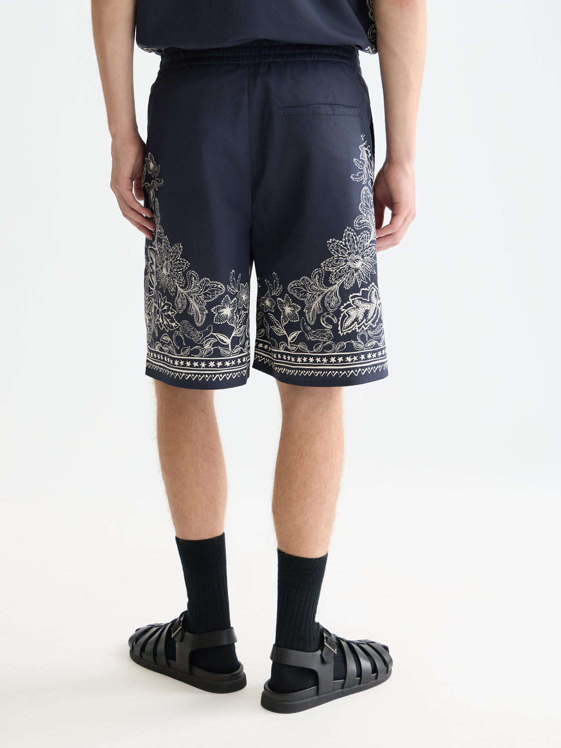 Printed shorts by Scotch & Soda featuring a colorful floral pattern, shown from the back view.