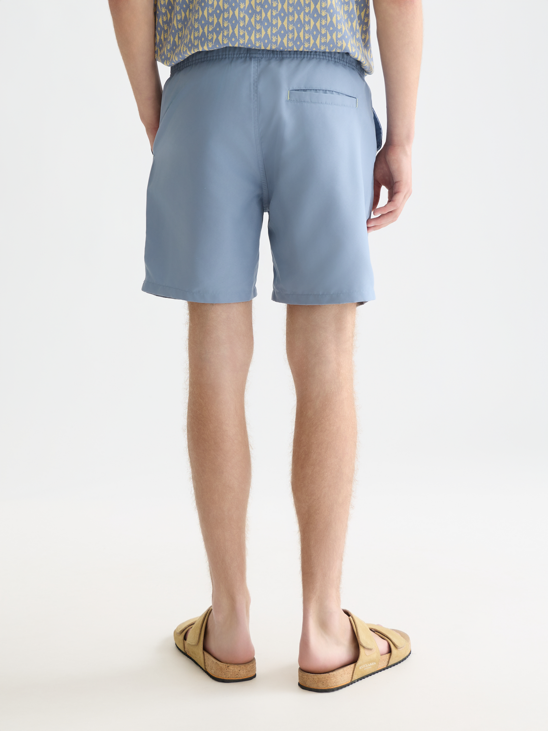 Mid-length Scotch & Soda swim shorts in vibrant coral color, featuring a relaxed fit and elastic waistband.