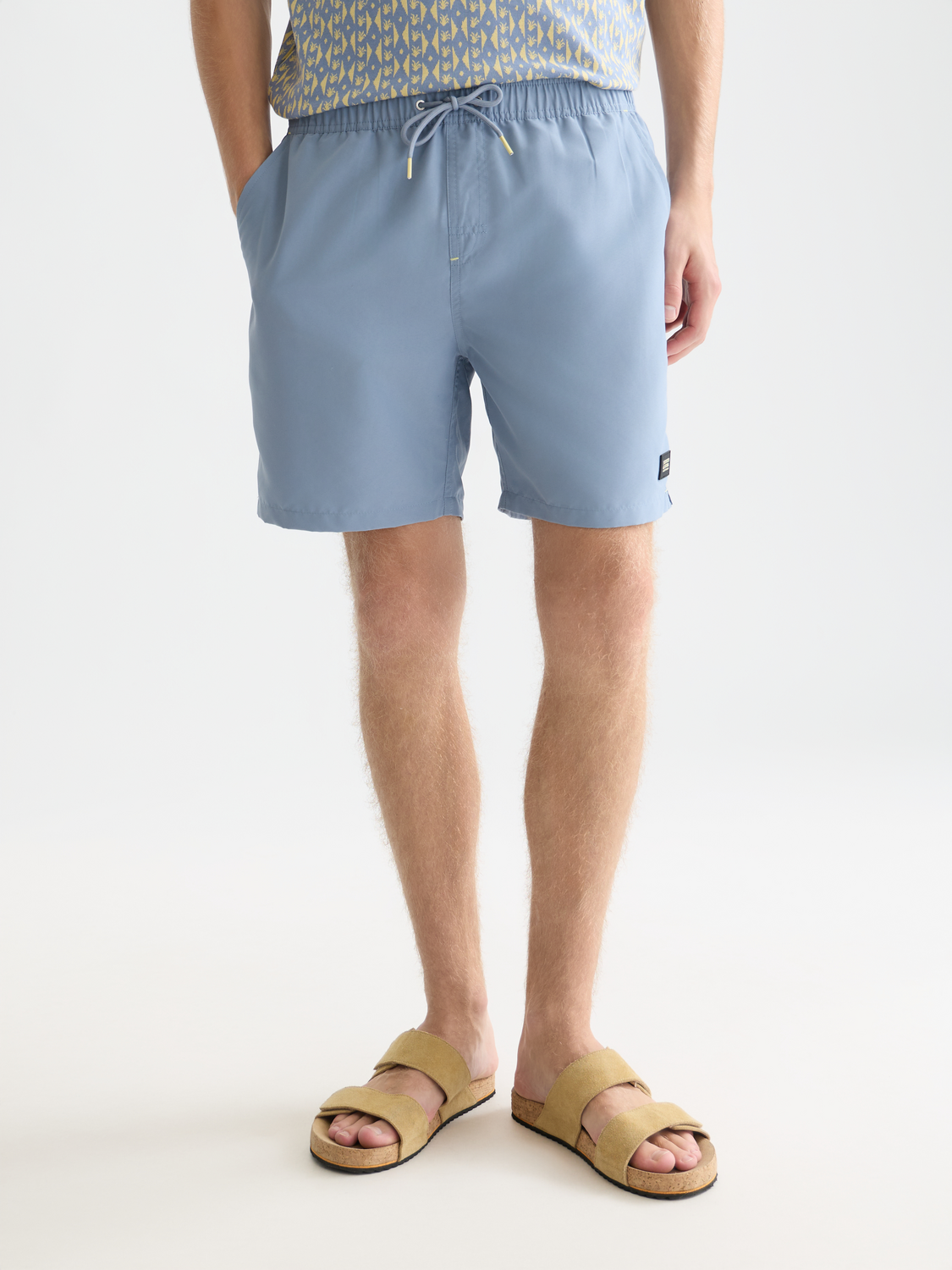 Mid-length SCOTCH & SODA swimshorts in coral color with a relaxed fit, displayed on a plain background.