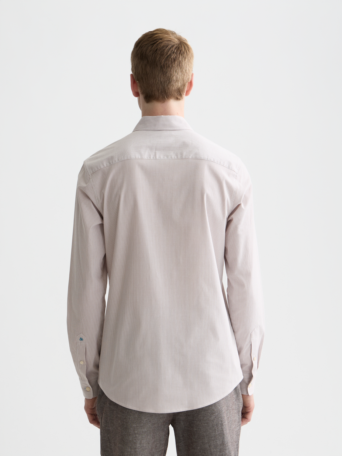 Long sleeve striped poplin shirt by Scotch & Soda, featuring a classic pattern and tailored fit on a model.