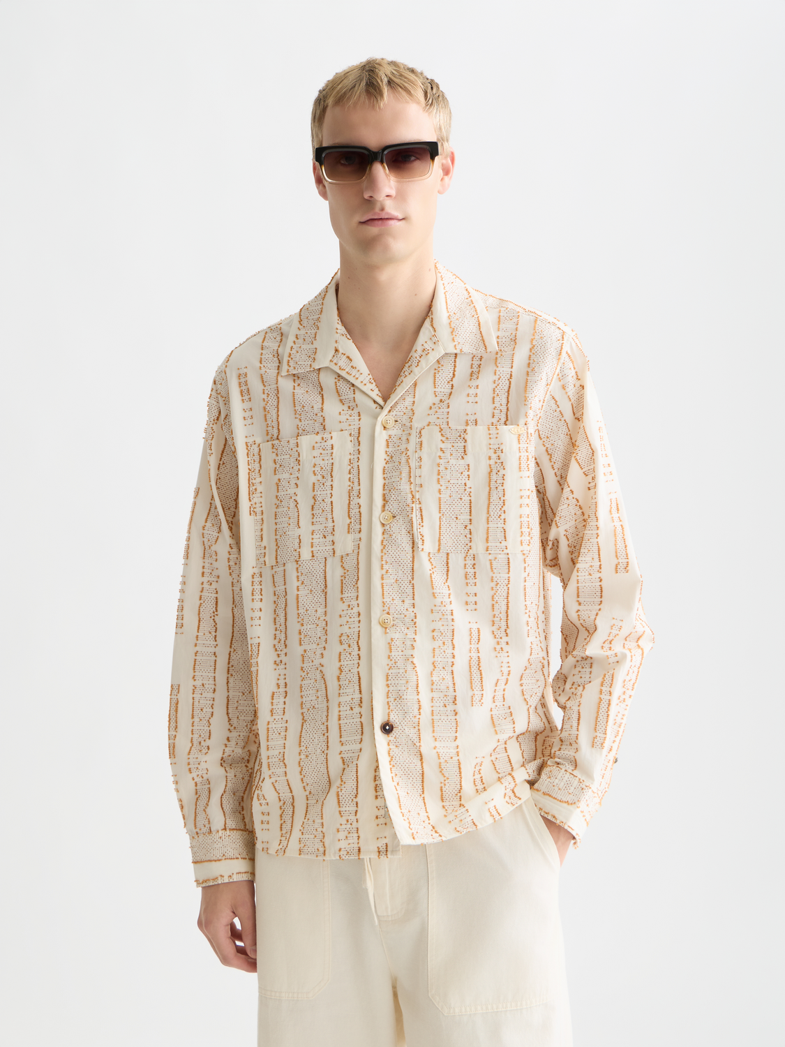 Long-sleeve Scotch & Soda jacquard structured shirt with detailed pattern and classic collar, shown in a close-up view.