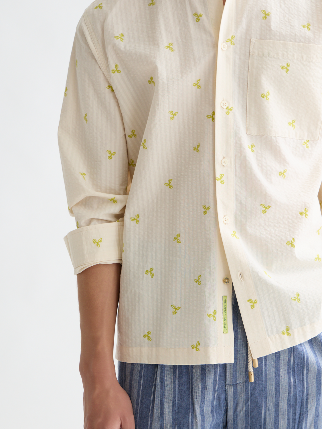 Long-sleeve seersucker shirt by Scotch & Soda with blue and white striped fabric, button-up front, and classic collar.