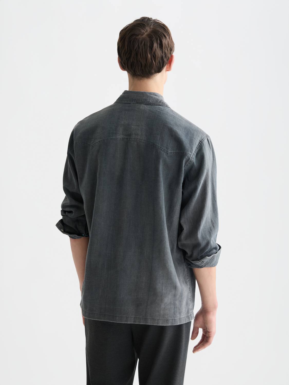 Scotch & Sodas washed denim long sleeve shirt with button-down collar, shown from the back in this product image.