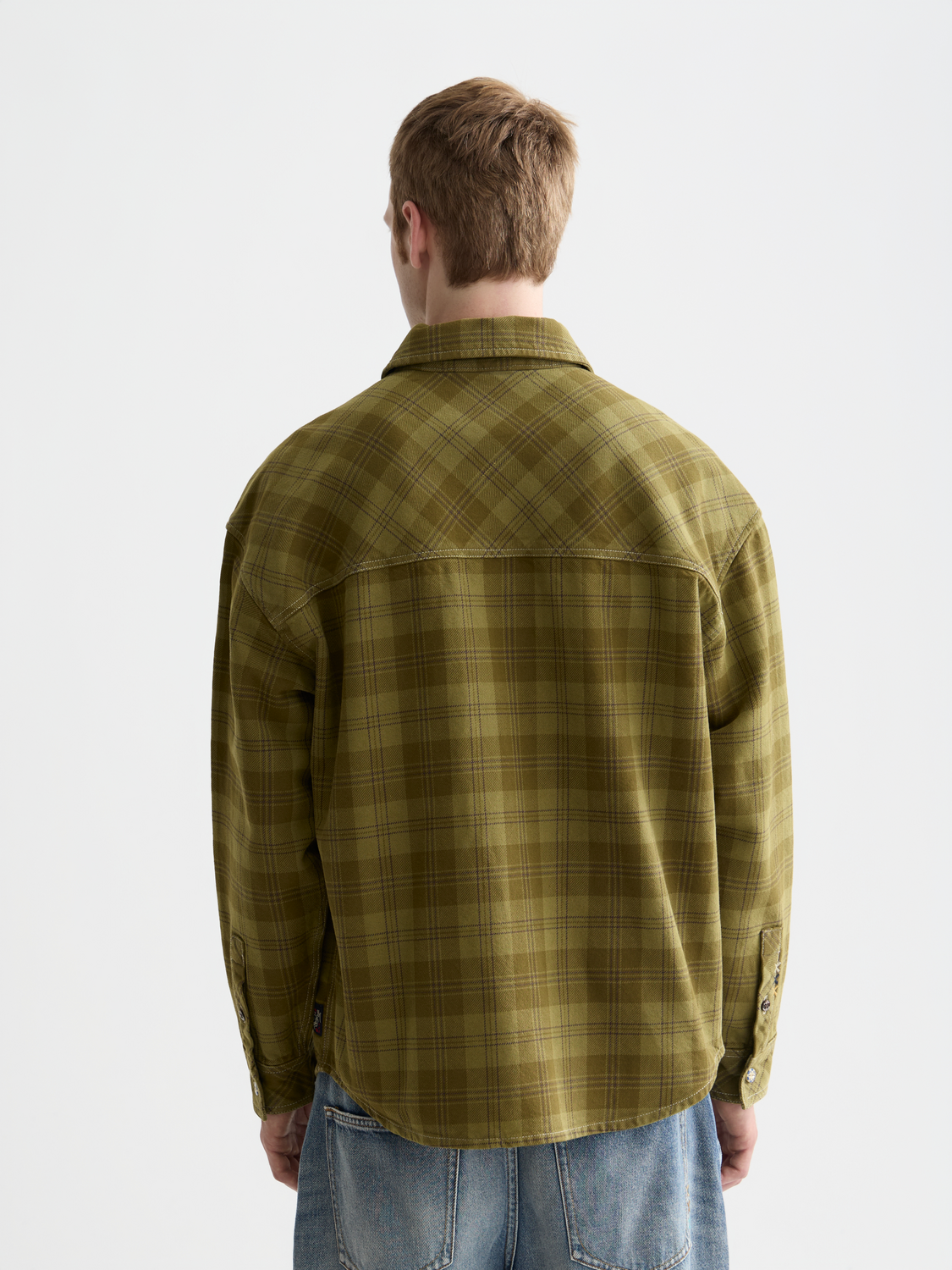 Checked overshirt jacket by Scotch & Soda with button closure and collar, featuring a classic plaid pattern in neutral tones.