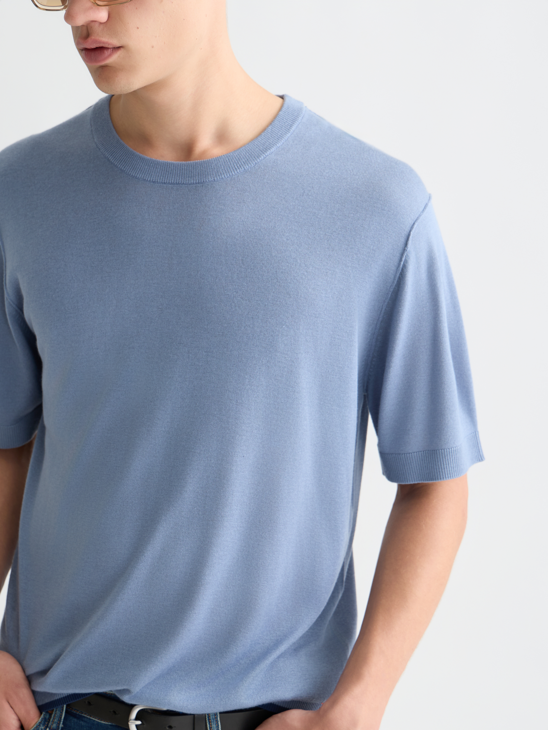 Close-up of a Scotch & Soda knitted T-shirt, showcasing the textured knitwear fabric and detailed stitching.