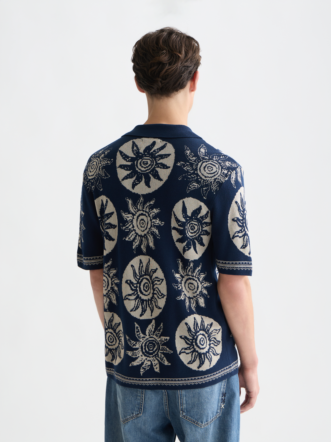 Knitted jacquard short-sleeved shirt by Scotch & Soda, showcasing detailed knit pattern and short sleeves on a neutral background.