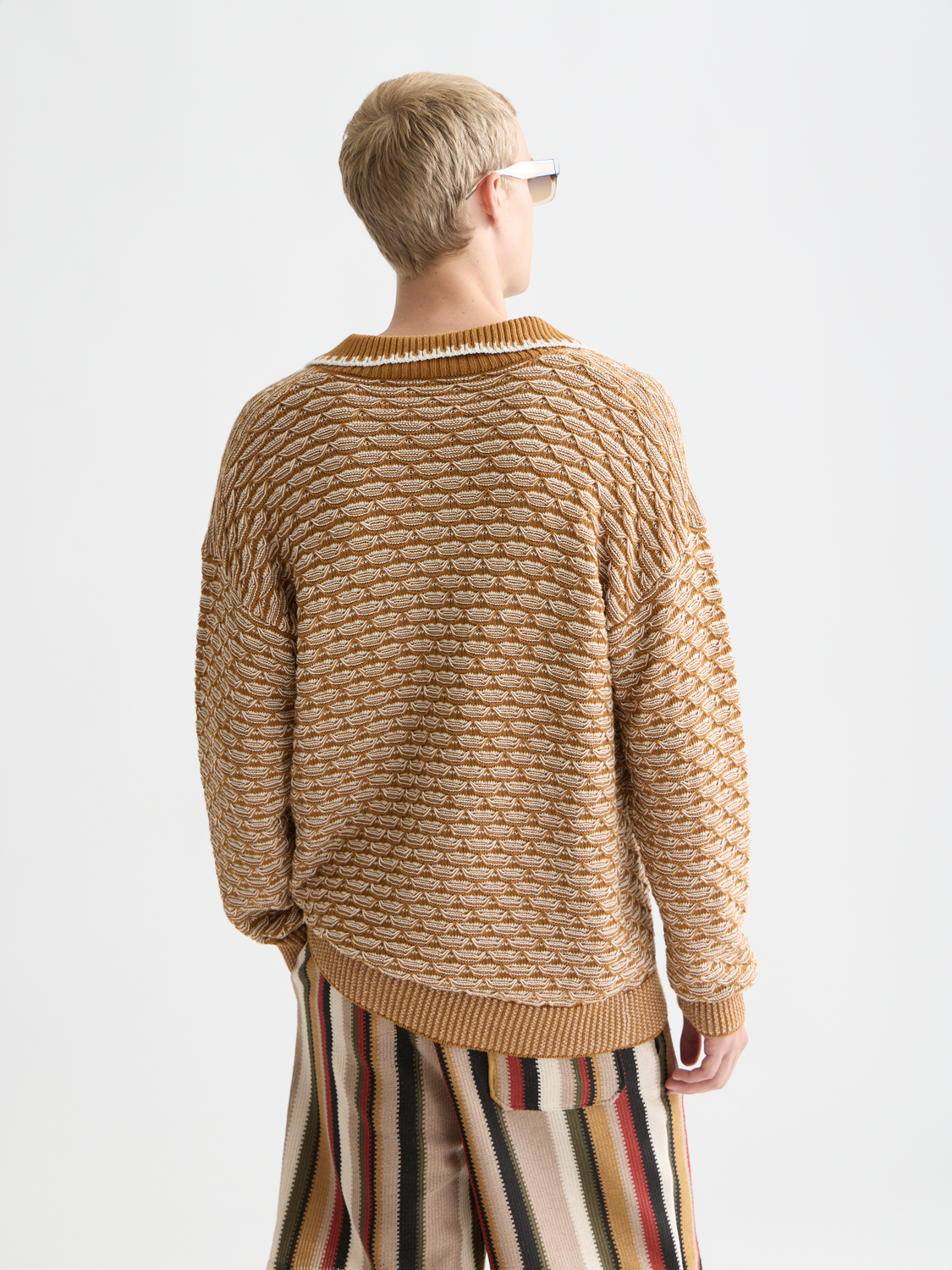Dropped shoulder knit polo sweater by SCOTCH & SODA, featuring a textured knit design and a relaxed fit, shown from the back.