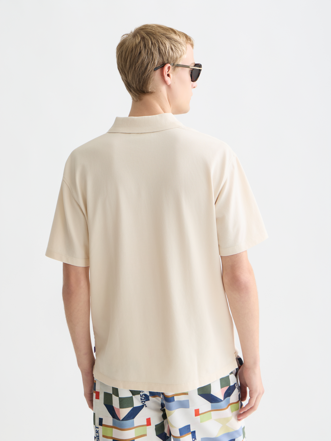 Navy Scotch & Soda pique polo shirt with collar and short sleeves, shown from the back.