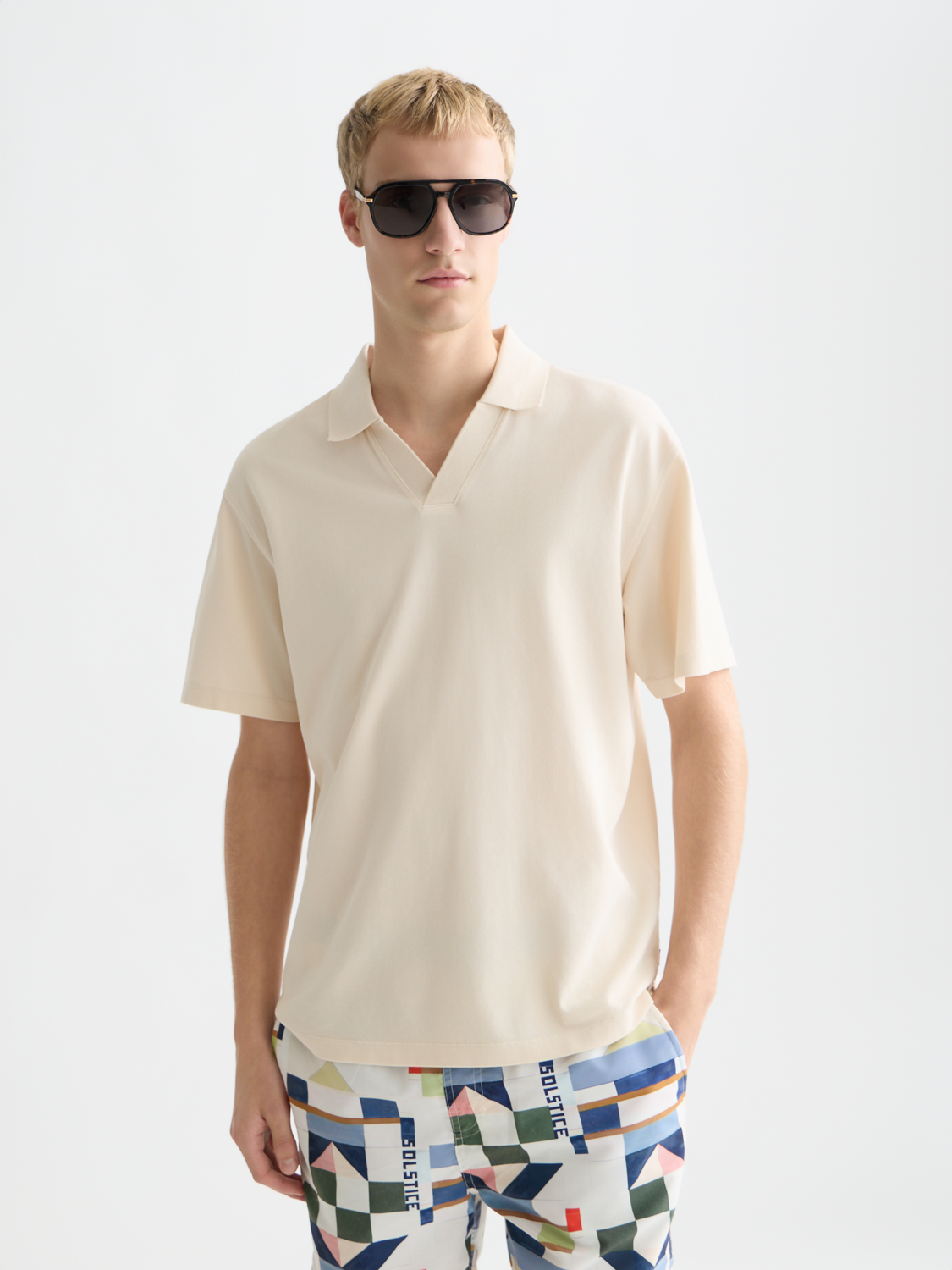 Men's navy blue Scotch & Soda pique polo shirt with a classic collar and short sleeves, shown on a model.