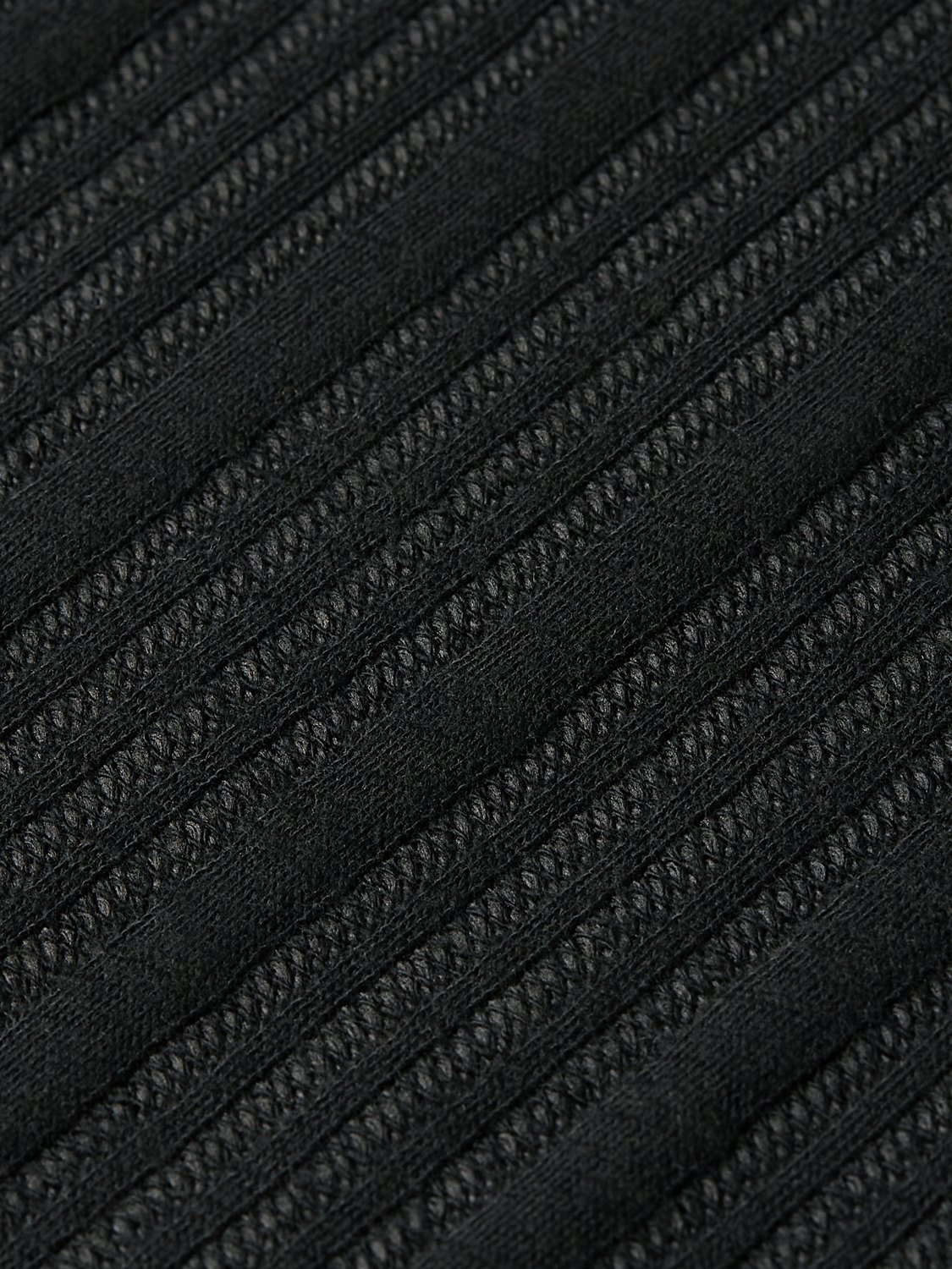 Ribbed polo shirt by Scotch & Soda, featuring a classic collar and textured fabric, shown in a close-up view.