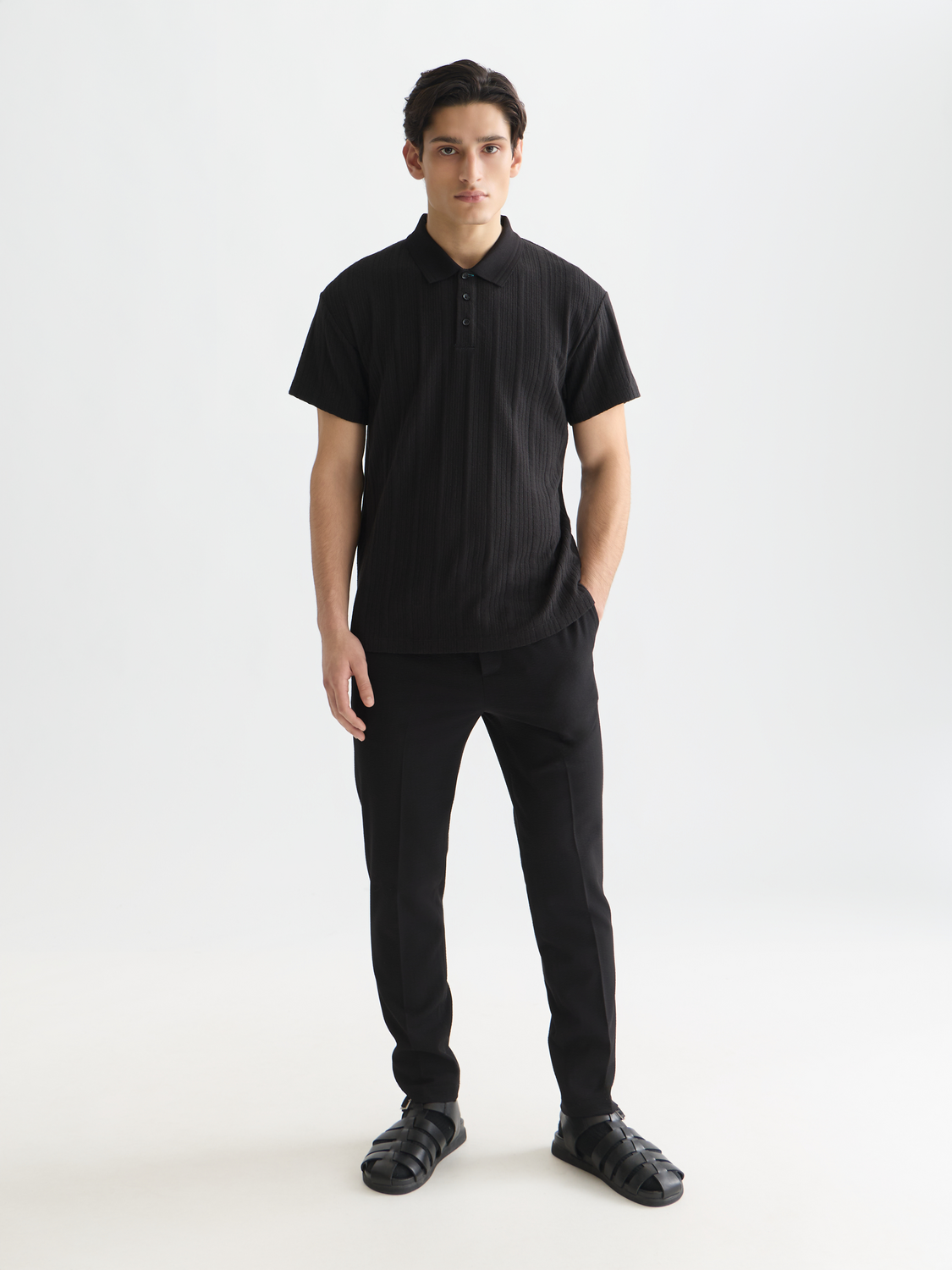 Navy ribbed polo shirt from Scotch & Soda, featuring a classic collar and short sleeves on a plain background.