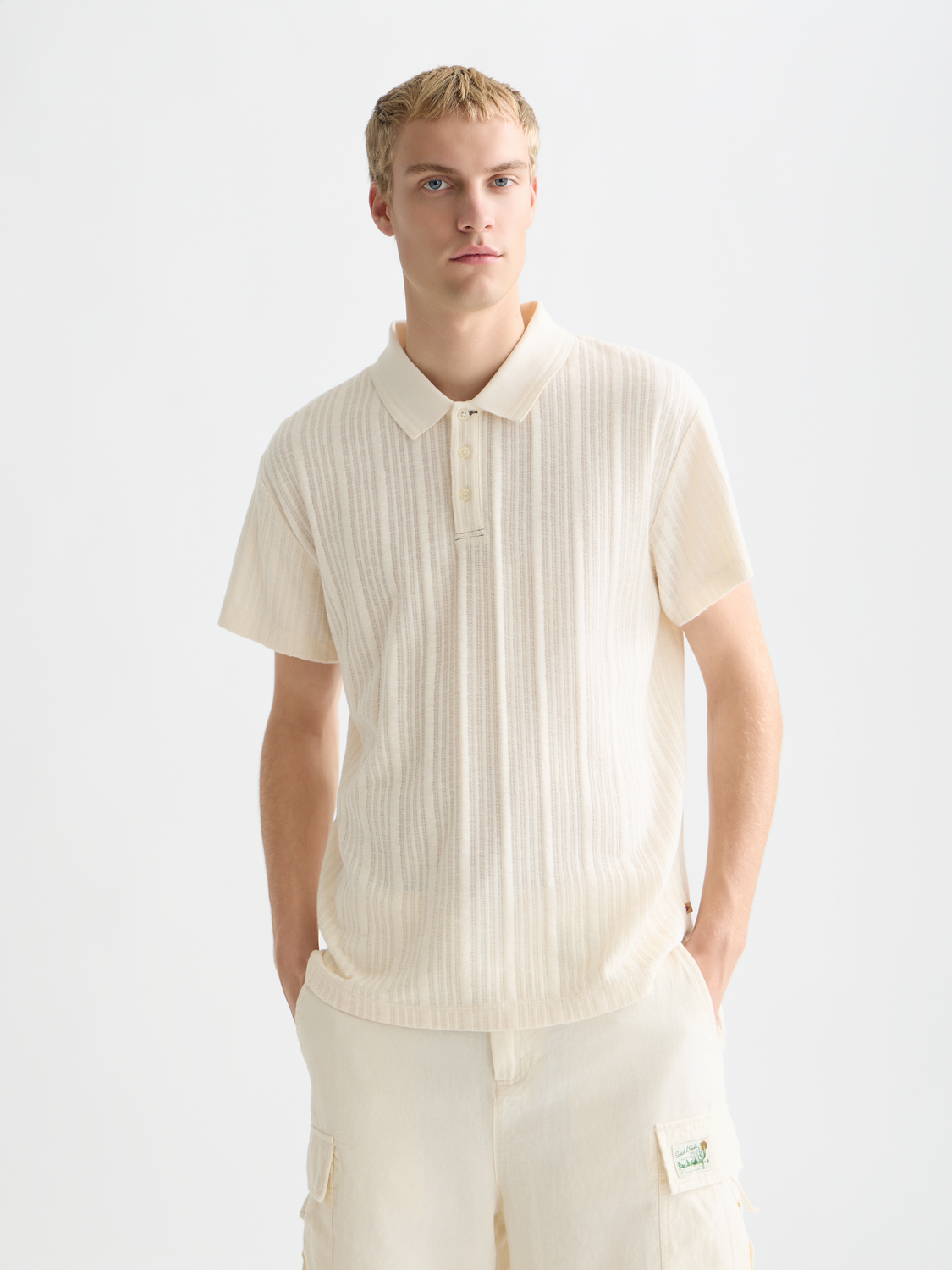 Ribbed navy polo shirt by Scotch & Soda featuring a classic collar and short sleeves, displayed on a plain background.
