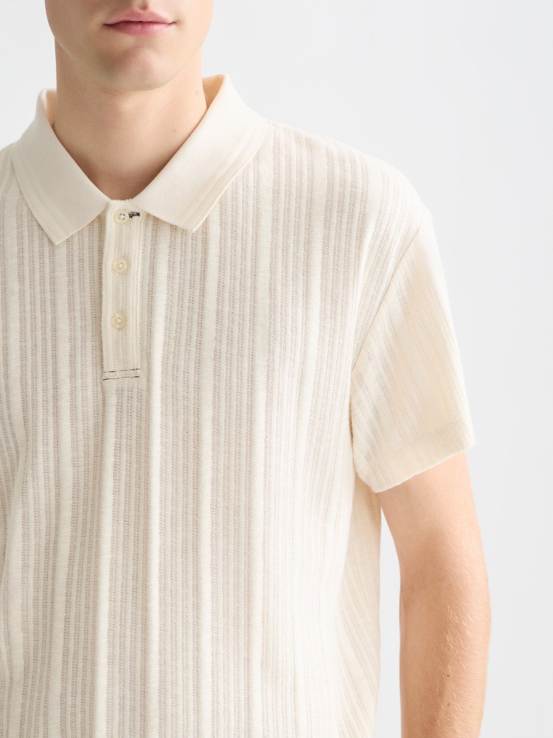 Ribbed SCOTCH & SODA polo shirt in neutral color, featuring a classic collar and textured fabric detail.